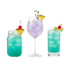 Three colorful tropical cocktails with fruit garnishes on a white background