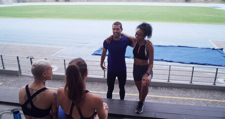 Couple of friends, athlete and people at stadium for sports break, talking and fitness at training....