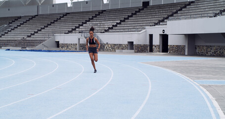 Fitness, race track and woman running for sports, exercise and practice with energy outdoor....