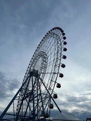 Ferris Wheel Against Cloudy Sky