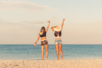 Two young women enjoying summer beach day