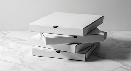 A stack of four blank white pizza boxes, neatly arranged on a marble surface.