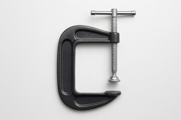 Metal C clamp isolated on white background, industrial tool close up heavy duty iron equipment workshop object mechanical pressure device construction repair hardware tightening concept steel clampwor