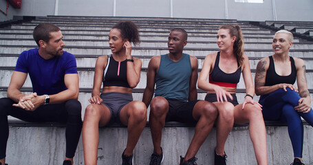 Fitness, friends and talk at stadium for relax, sports or advice with runners outdoor together. Group, break and conversation with happy athlete for health, communication or exercise tips with people