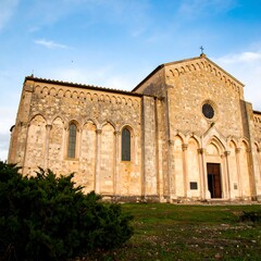 Obraz premium Ancient stone church facade, low angle view, set against a clear blue sky