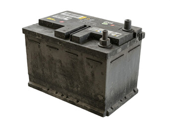 A slightly dirty car battery is shown on a white background with terminals visible on top