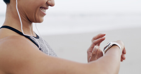 Hands, music and woman with smart watch for fitness, heart rate or exercise progress. Earphones, happy runner and check wristwatch for wellness stats, timer and pace tracking for cardio at beach