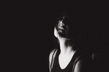 Sensual portrait of a woman with dark hair, done in a low key style.