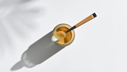 Golden Elegance A Jar of Creamy Delight Captured in a Minimalist Still Life with a Play of Light and Shadow, Evoking Warmth and Culinary Satisfaction in a Serene Composition