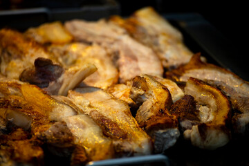 pork belly slices being pan-fried or grilled