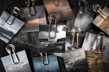 Collection of black and white and color photographs pinned together showcasing diverse landscapes and textures captured in various lighting conditions