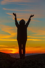 Fototapeta premium beautiful mature women in the mountains at sunset on a summer day
