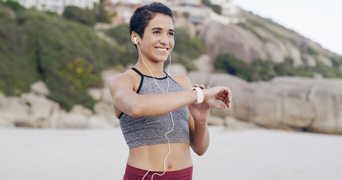 Fitness music, thinking and woman with smart watch at beach for heart rate or exercise progress. Earphones, happy runner or check wristwatch for wellness stats, timer or pace tracking with reflection - Powered by Adobe