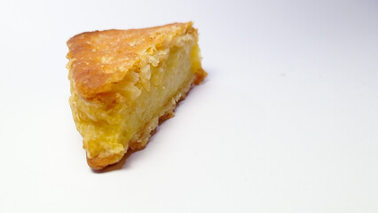 Slice of Lemon Pie with Golden Crust on White Background