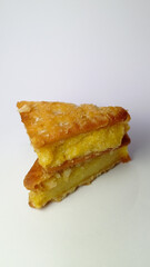 Fried potato wedges stacked on white surface with crispy golden crust and soft interior