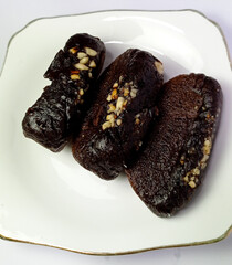 Dark Chocolate Rum Rumballs with Nut Topping on White Plate