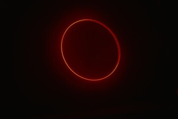 A glowing red circular light against a dark background