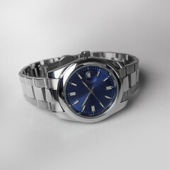 silver iron watch with blue dial isolated on white background