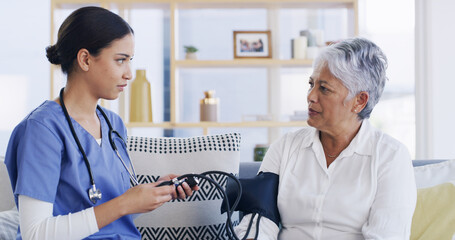 Nurse, old woman and blood pressure test on sofa for assessment, hypertension or advice at house....