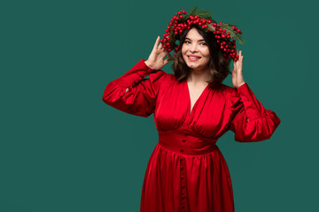 Smiling female model in red attire with floral wreath