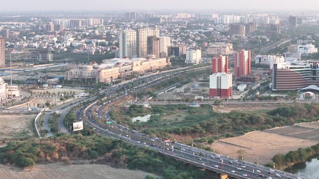 Cars moving on a highway in india in lucknow city with buildings in the background 