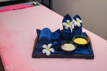 Spa treatment setup with towels and flowers
