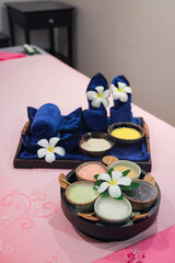 Spa treatment set with herbal scrubs and towels
