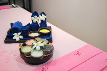 Spa treatment set with herbal scrubs and towels
