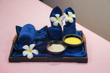 Spa treatment setup with towels and flowers
