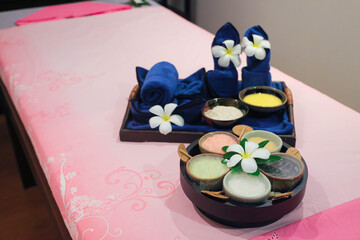 Spa treatment set with herbal scrubs and towels
