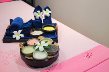 Spa treatment set with herbal scrubs and towels
