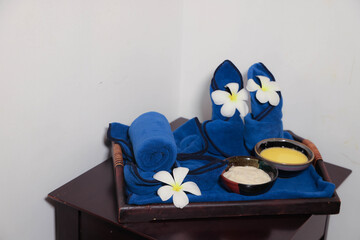 Spa tray with towels, flowers, and skincare bowls
