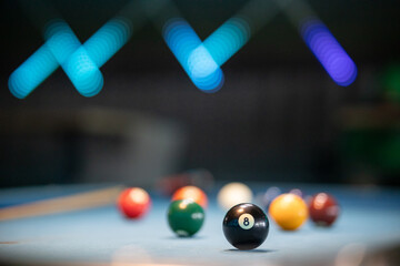 Close-Up of Billiard Balls on Table with Blurred Cue Stick in Background