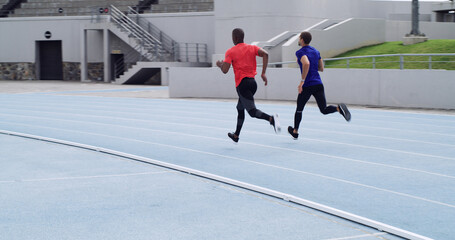Back, men and running a race at stadium for competition workout, speed training and performance....