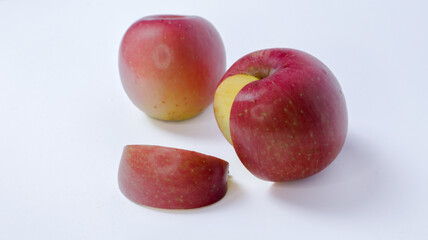 Red apple with a bite on side, showing white flesh inside, isolated on white background.Half apple...
