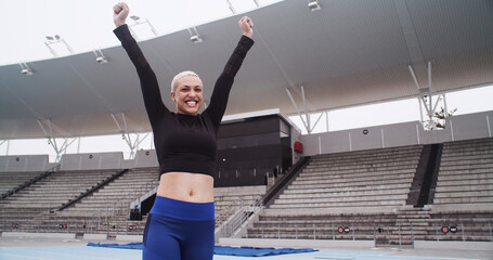Cheering, athlete and woman at stadium, celebration or excited for complete fitness goal or...