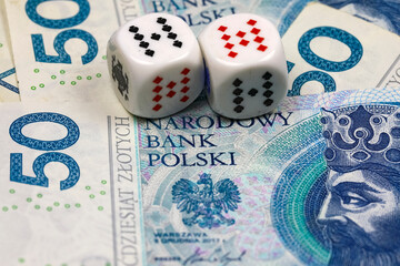 Polish Zloty banknotes and a pair of rolled dice