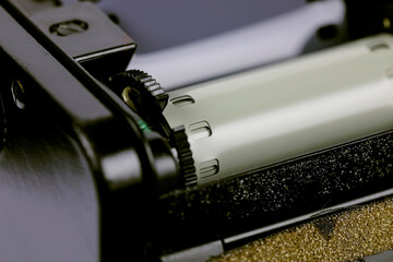 The film compartment of an old 35mm SLR is open and the film is inside