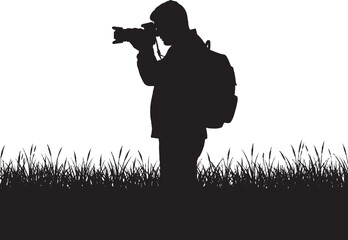 Naklejka premium Photographer Silhouette in Grass with Camera and Backpack