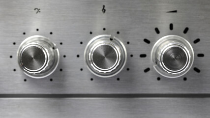 Three knobs, a detail of the amplifier panel