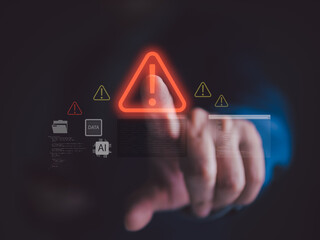 Cybersecurity warning concept with hand touching virtual alert icon, representing data breach,...