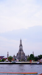 Boat trip on the Chao Phraya River with Wat Arun in the background in Bangkok, Thailand.