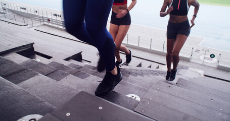 People, legs and running on stairs at stadium for fitness, cardio exercise and marathon practice....