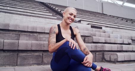 Break, exercise and portrait of woman on stadium bleachers for fitness, training or workout as...