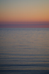 Beautiful and tranquil pastel-colored seascape and sky at sunset. Abstract natural landscape and background with copy space.