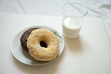 A light summer breakfast with donuts and a glass of milk. Soft natural light, calm mood, and...