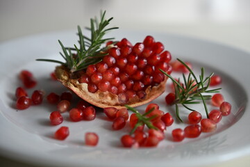 Close-up of fresh pomegranate seeds with rosemary. A nutrient-dense fruit rich in antioxidants, vitamin C, and fiber. Ideal for dietitians, nutritionists, and healthy lifestyle visuals.