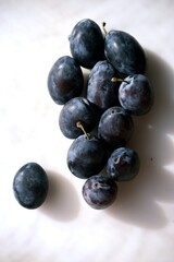 Close-up of fresh ripe plums symbolizing autumn harvest. Perfect for making sweet jam, marmalade, or jelly. Seasonal fruit full of flavor and natural sweetness.