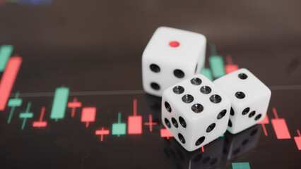 White dice on financial chart symbolize risk and chance in trading, with focus on market...