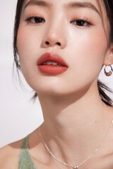 Close-up portrait of a young woman with bold lips and subtle makeup.